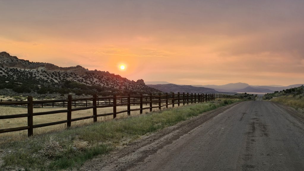 Watts Fencing showing a sunset and a wood ranch fence