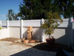 Privacy fence on top of solid stucco wall