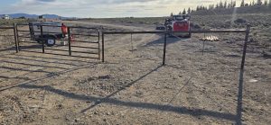 Metal Cattle Gate and Barbed wire fence on Ranch