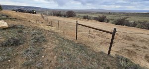Barbed Wire fence on dirt road with beautiful view